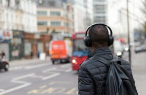 Person wearing headphones near a crosswalk.
